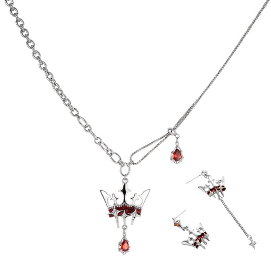 Silver-tone crown pendant with red zirconia stones and matching asymmetrical earrings on cream background