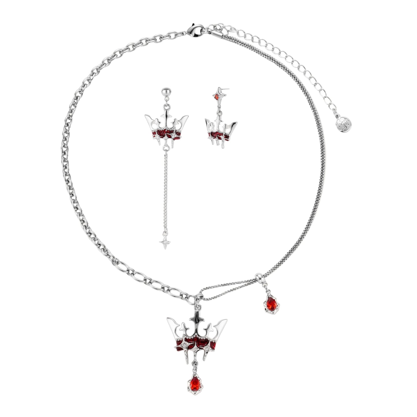 Silver-tone crown pendant with red zirconia stones and matching asymmetrical earrings on cream background