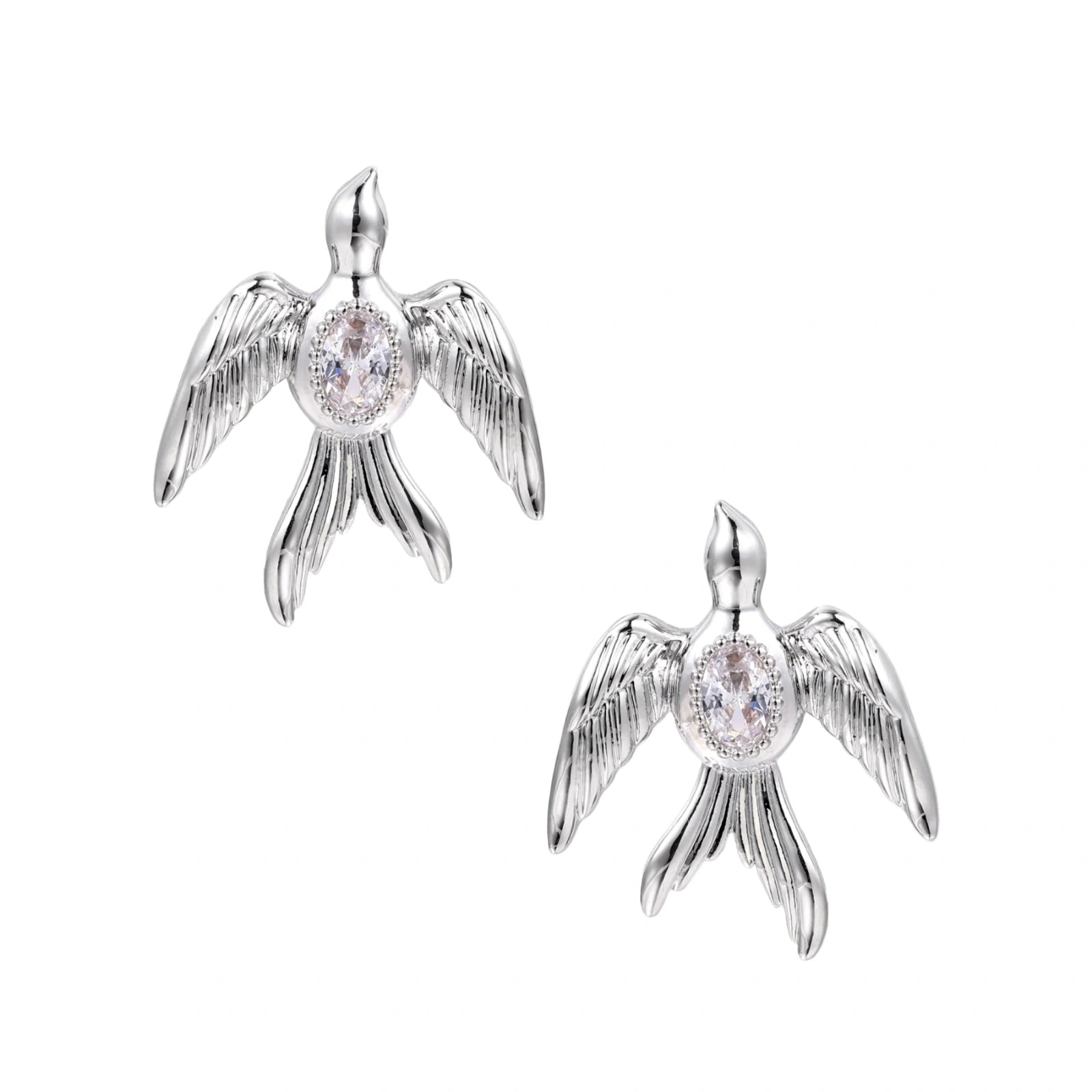 White gold-plated bird earrings with spread wings and oval zirconia center on cream background