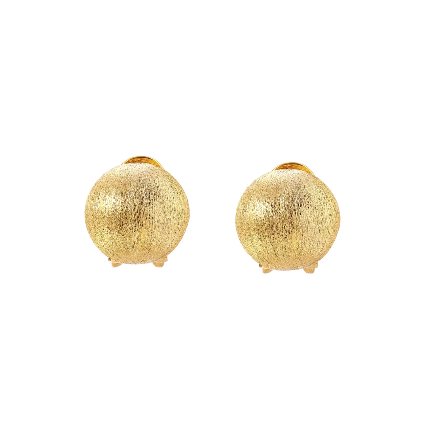 Pair of brushed gold dome earrings with clip backs showing textured matte finish on cream background