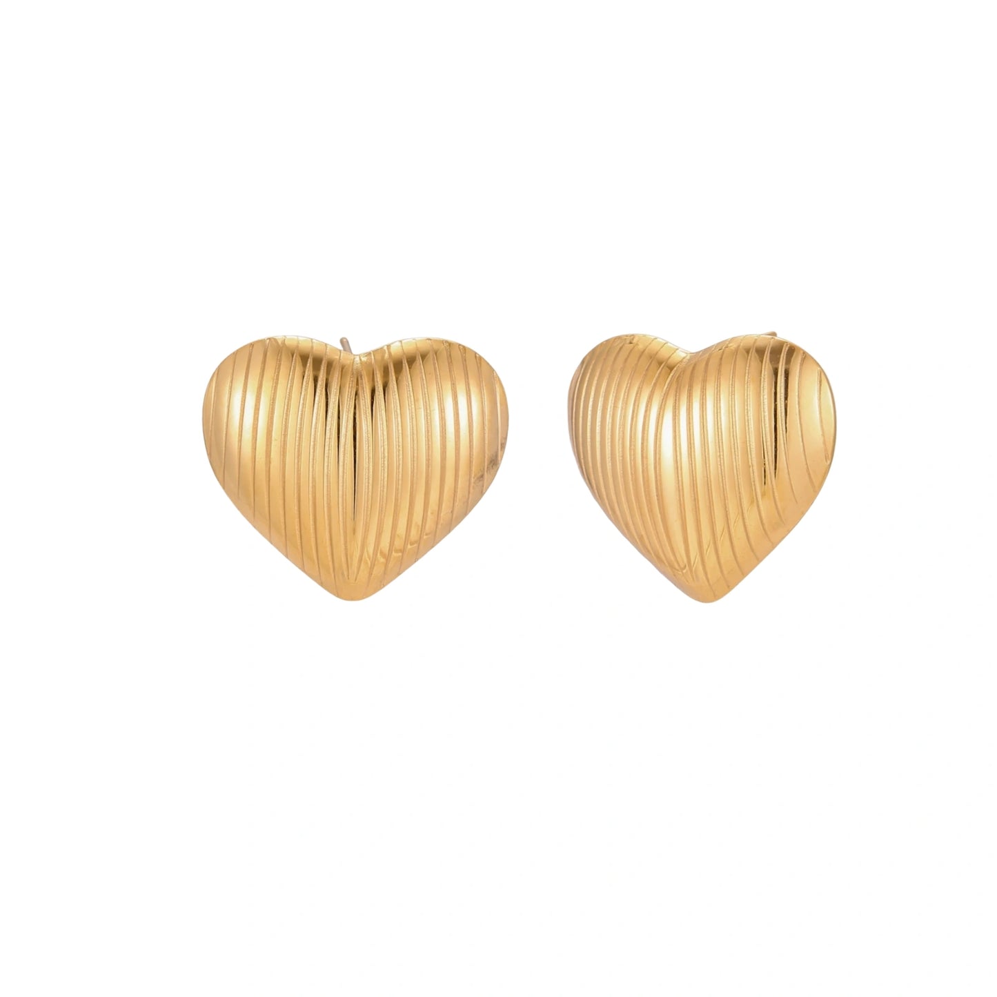 Gold heart-shaped stud earrings with parallel ridged texture on cream background