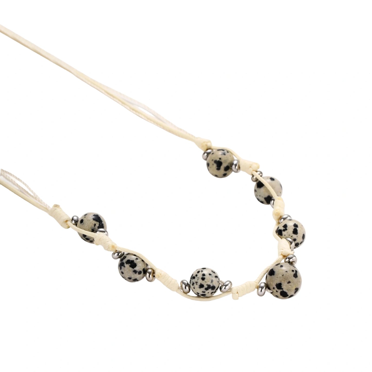Natural ammolite and quartz bead jewelry set with adjustable cream cord featuring cross charm on white background.