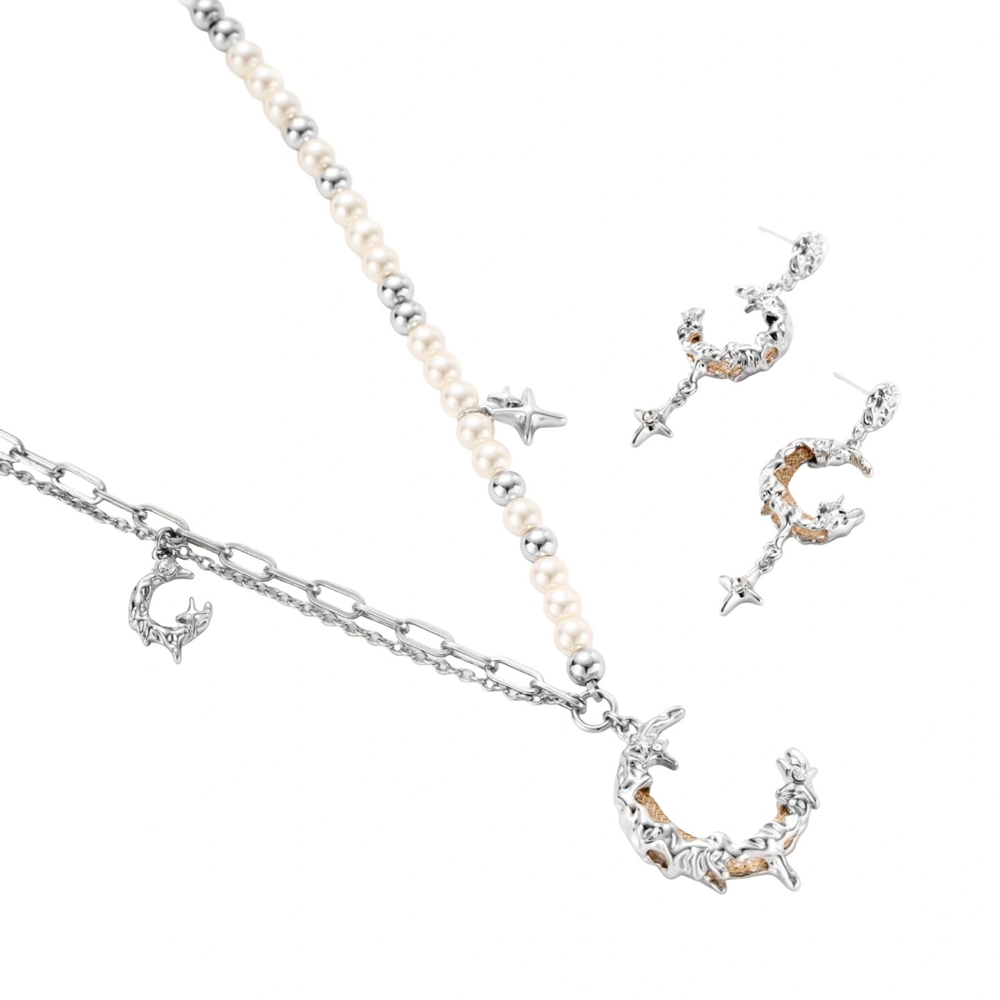 Mixed-metal jewelry set featuring layered necklaces with crescent moon pendant and pearl beads, plus matching star-drop earrings.