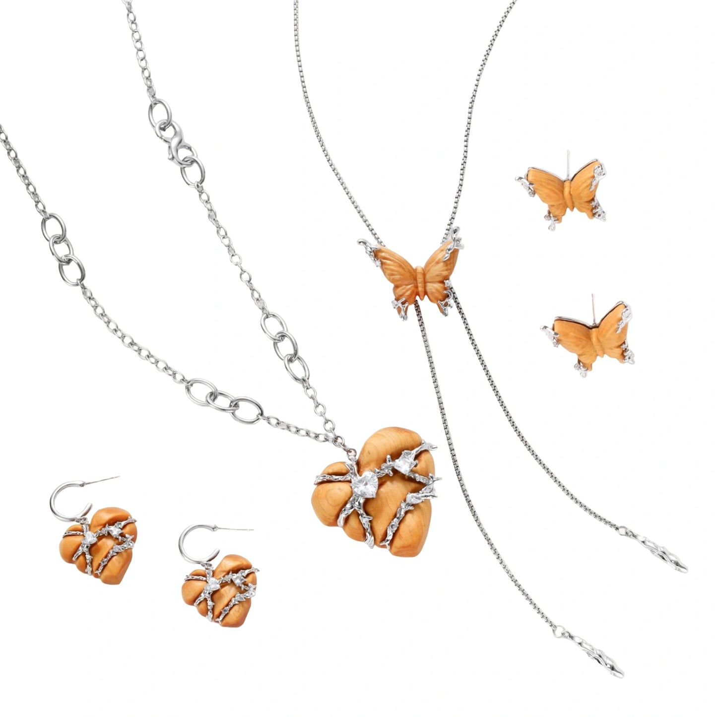 Amber wood butterfly pendant necklace with dangling chains and matching carved wood butterfly earrings on white background.