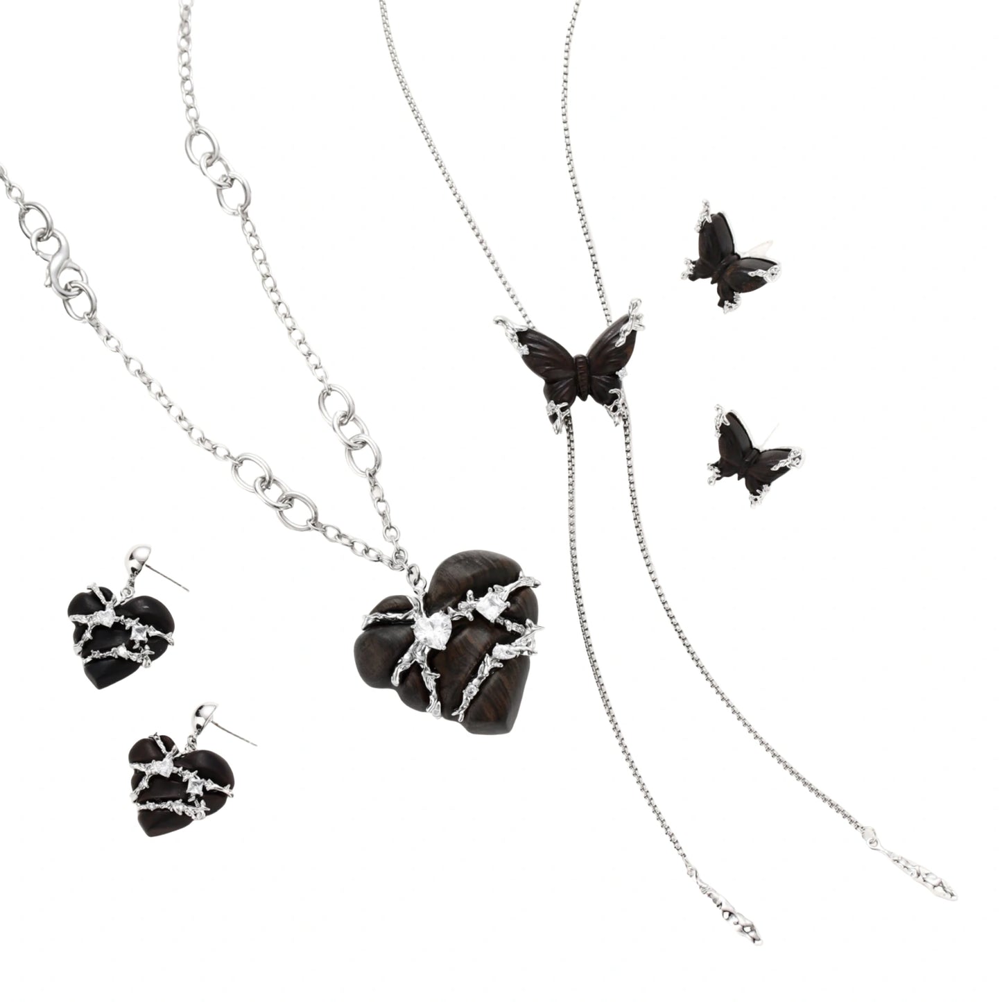 Dark wood butterfly earrings and necklace with silver chain accents on white background, showing natural grain texture.
