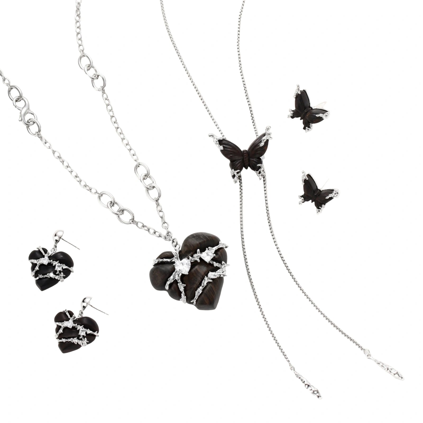 Dark wood butterfly earrings and necklace with silver chain accents on white background, showing natural grain texture.