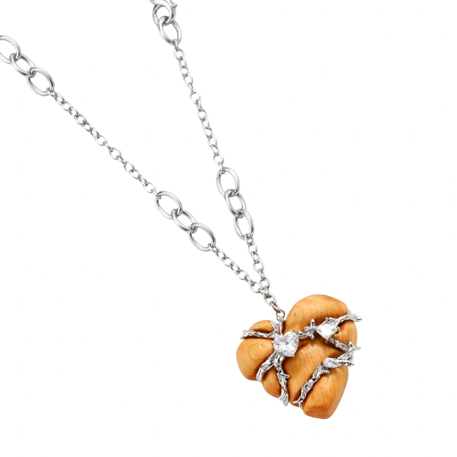 Heart-shaped eco-brass and wood jewelry set with silver wire detailing and crystal accents on cream background.