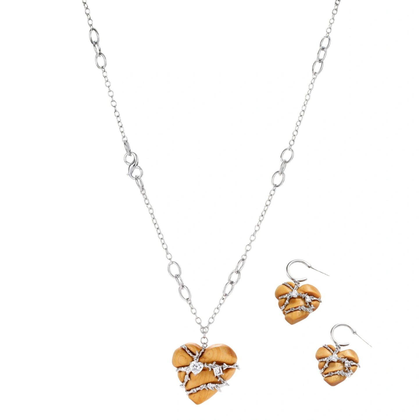 Heart-shaped eco-brass and wood jewelry set with silver wire detailing and crystal accents on cream background.