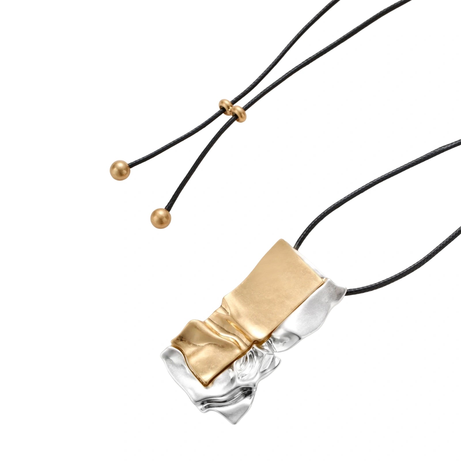 Modern jewelry set with abstract gold and silver pendant on black cord necklace plus matching geometric earrings on white background.