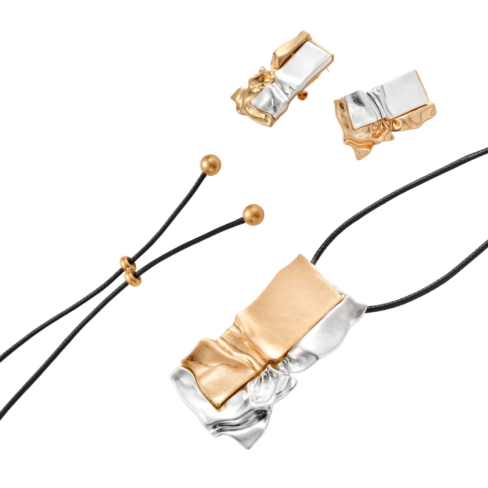 Modern jewelry set with abstract gold and silver pendant on black cord necklace plus matching geometric earrings on white background.