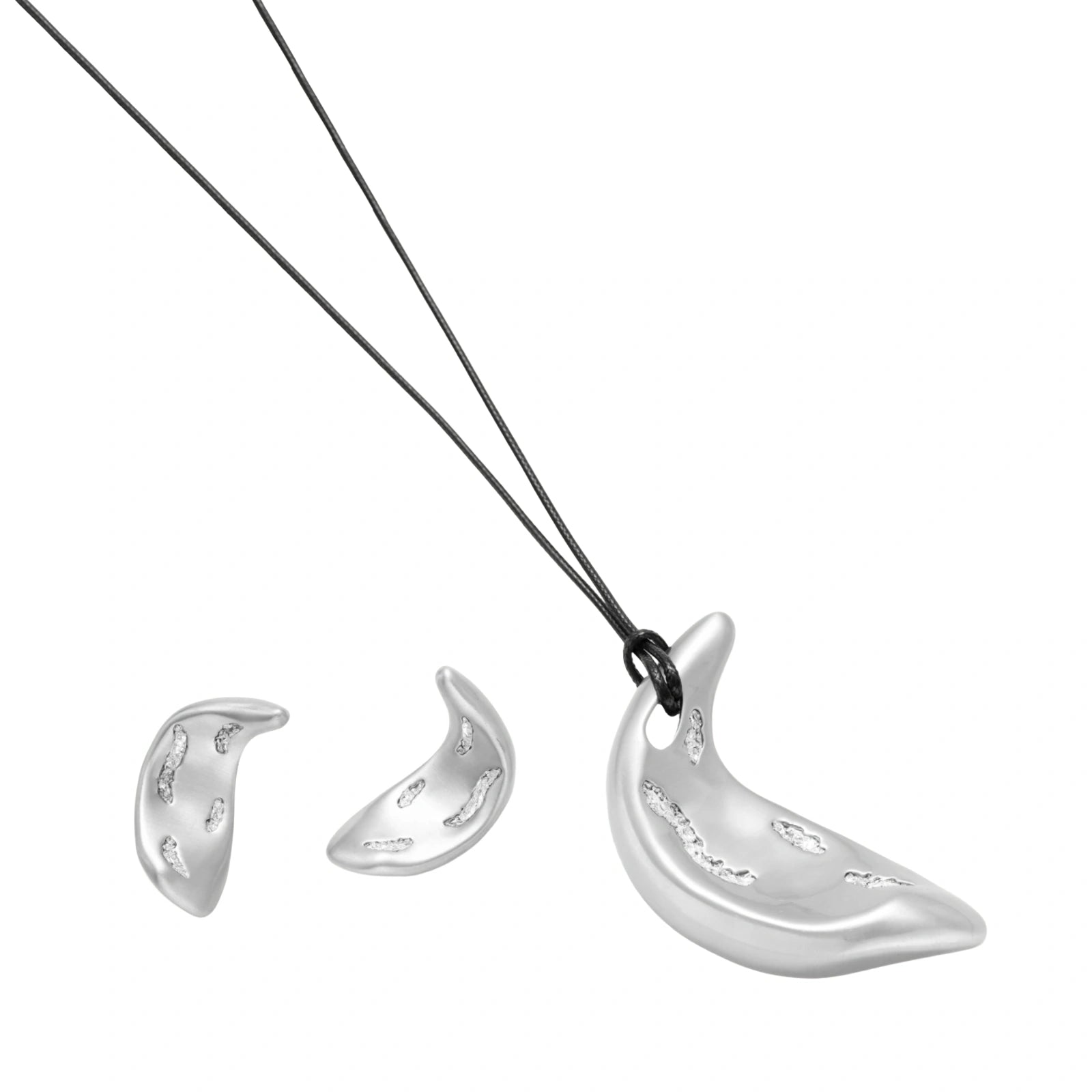 Crescent moon shaped pendant and earrings in eco-zinc alloy with curved crystal inlay patterns on light background.