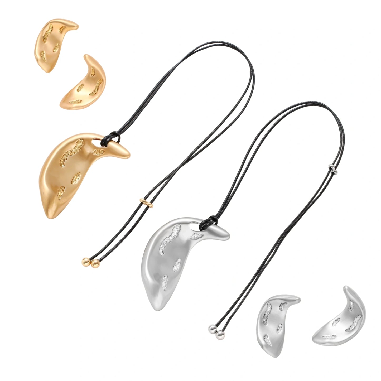 Crescent moon shaped pendant and earrings in eco-zinc alloy with curved crystal inlay patterns on light background.