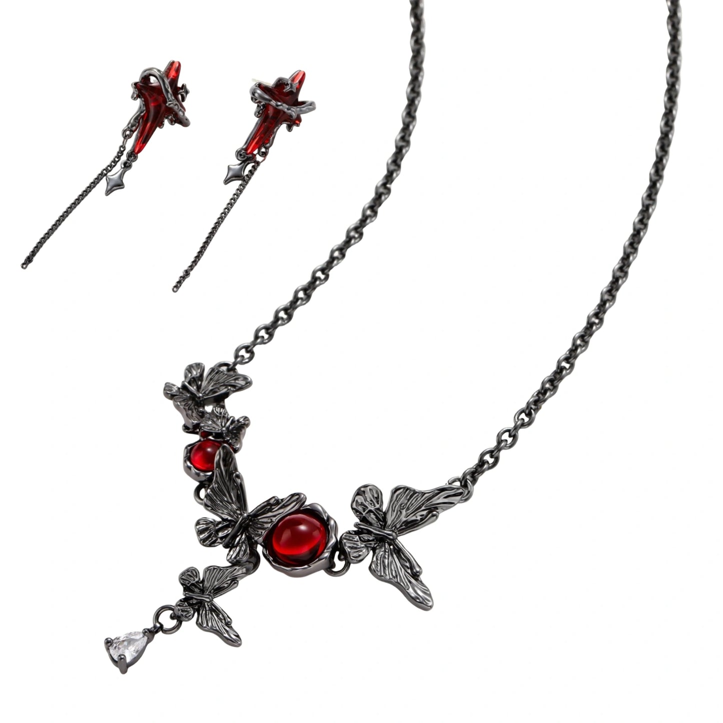 Gothic jewelry set with red resin cross pendants wrapped in dark metal chains on cream background.
