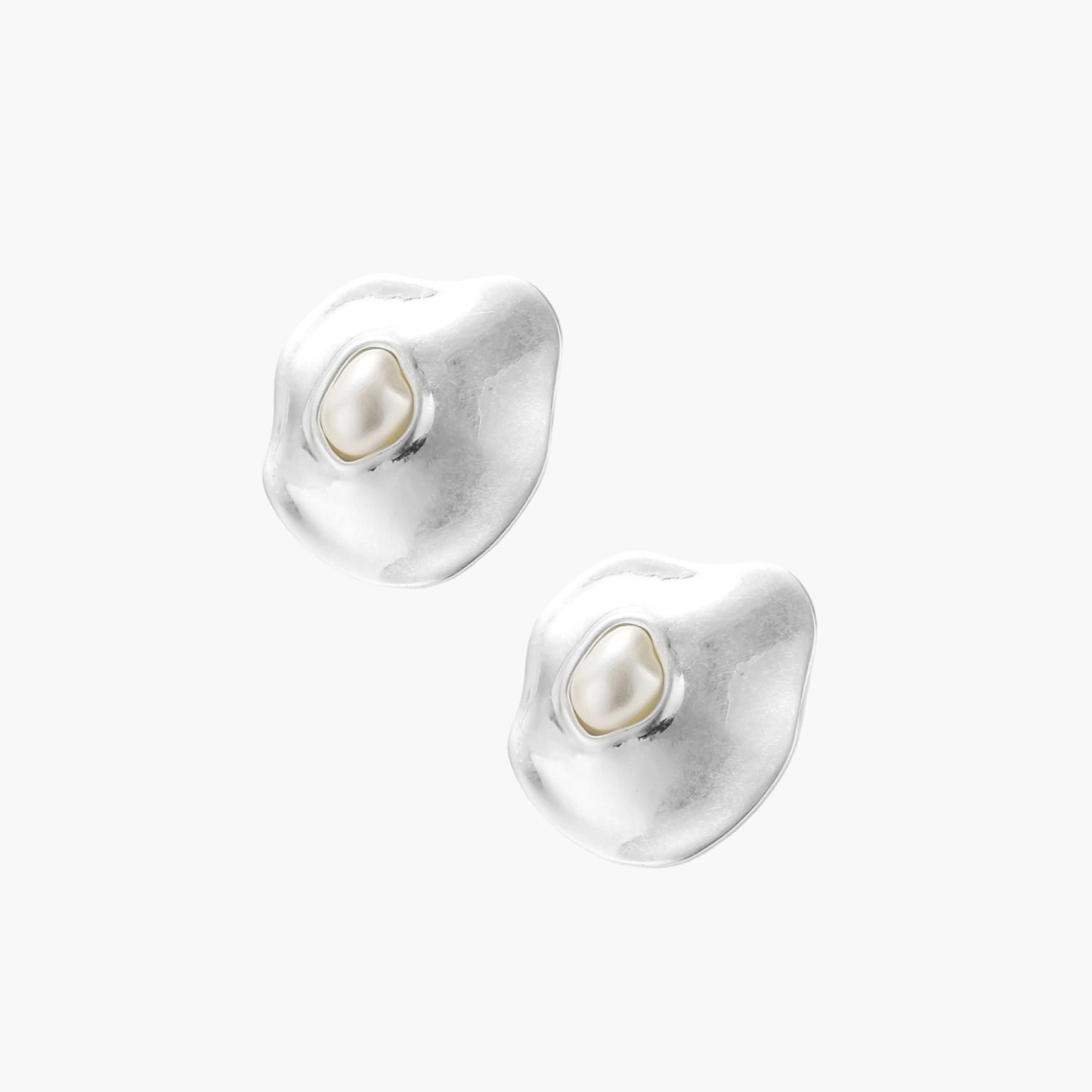 Organic silver stud earrings with white resin pearl centers in fluid stone-like shapes on light background.