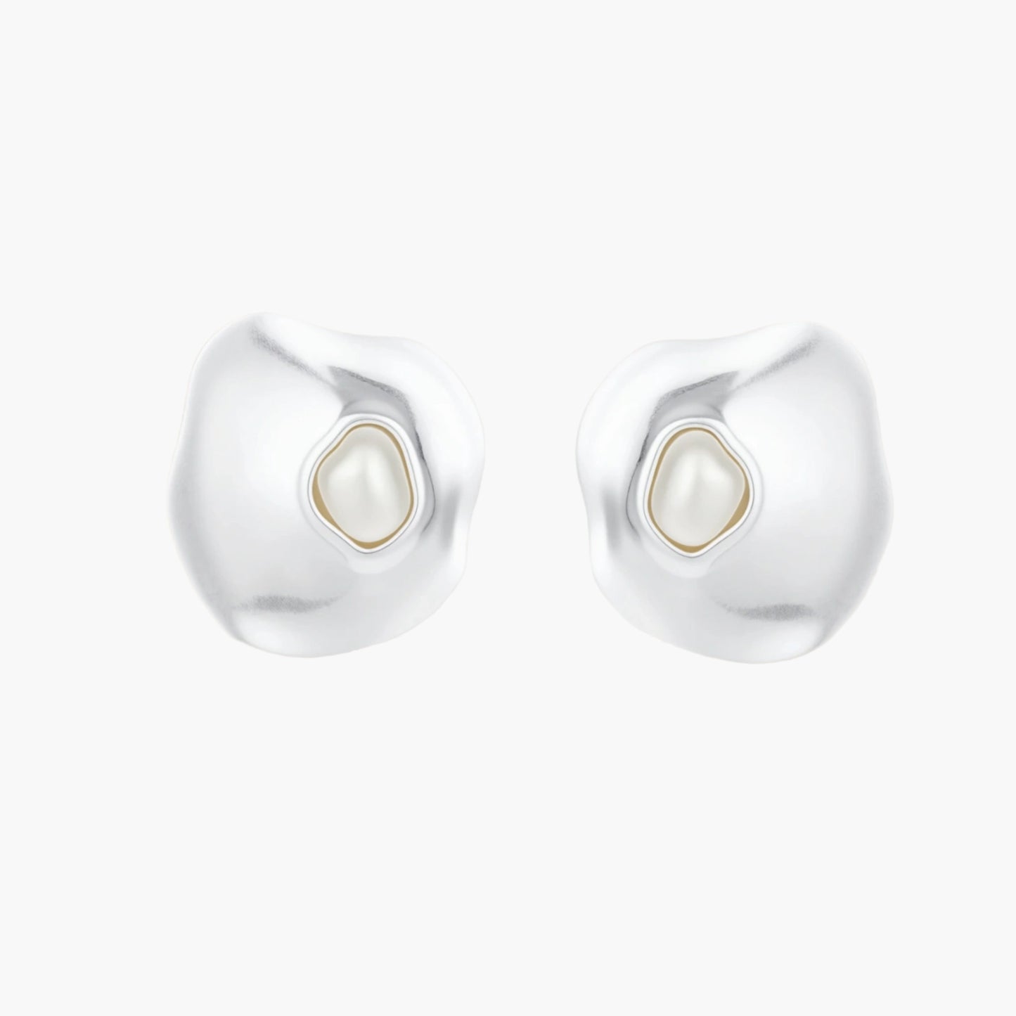 Organic silver stud earrings with white resin pearl centers in fluid stone-like shapes on light background.