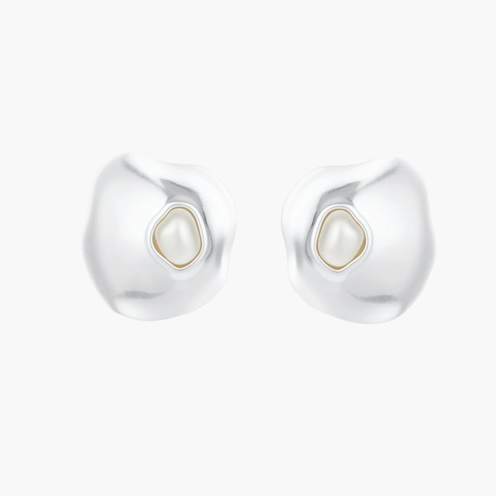 Organic silver stud earrings with white resin pearl centers in fluid stone-like shapes on light background.