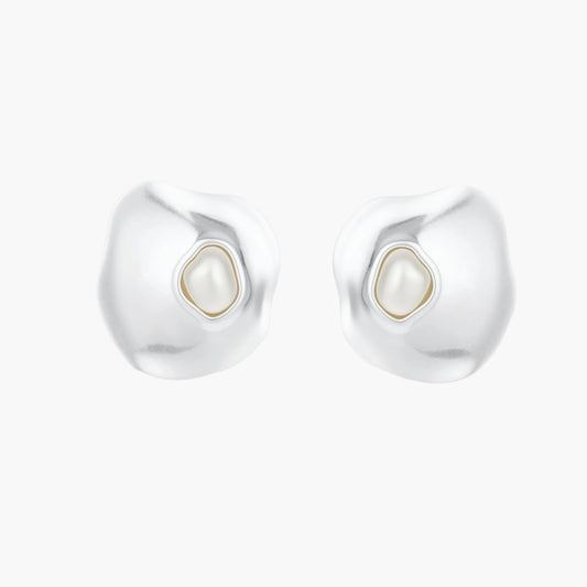 Organic silver stud earrings with white resin pearl centers in fluid stone-like shapes on light background.