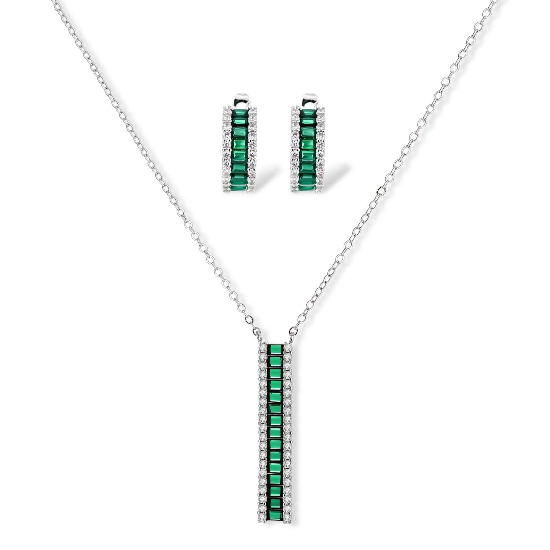 White gold plated jewelry set with emerald green rectangular stones and clear crystals in geometric rows on white background.