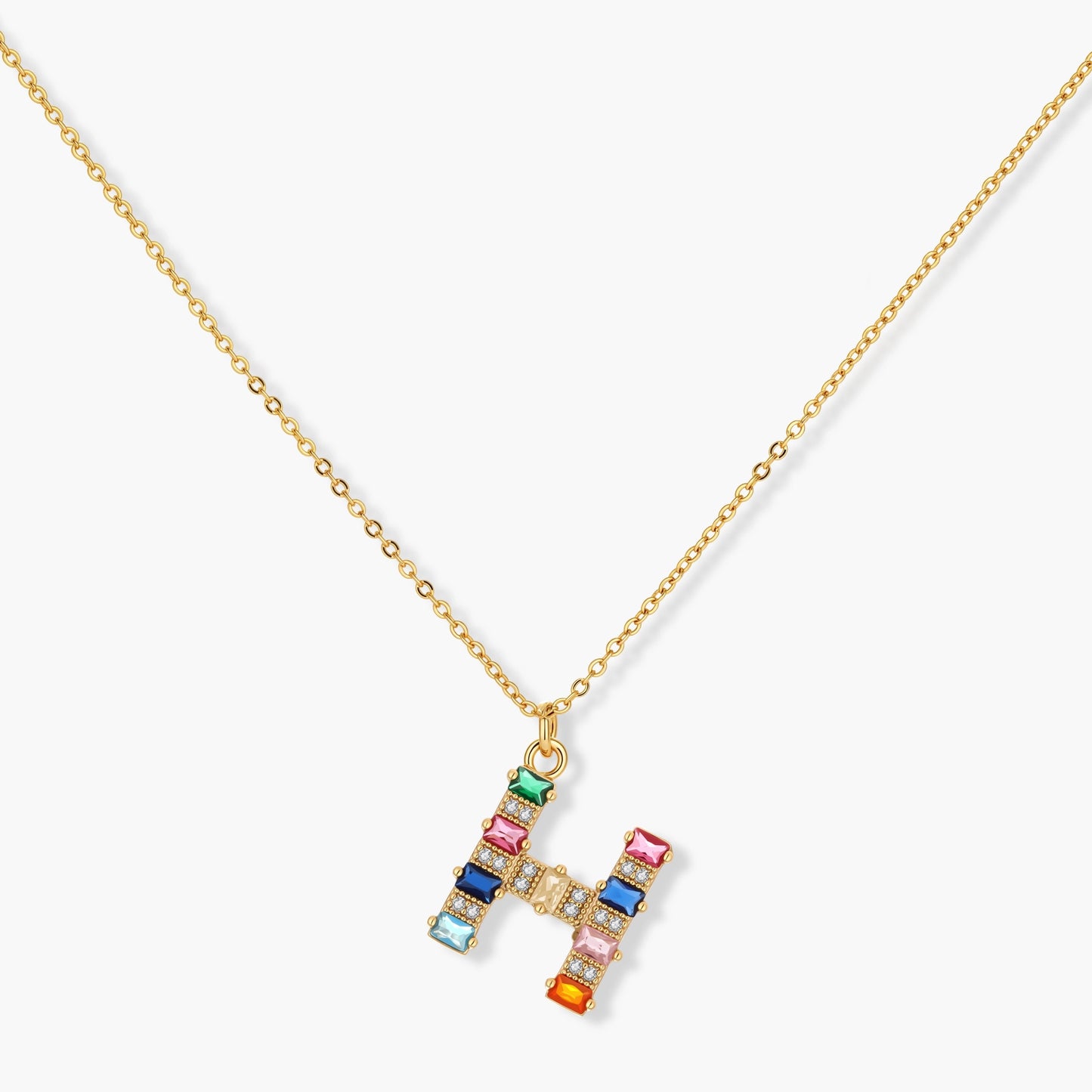 Gold-plated letter H jewelry set with multicolor zirconia stones in emerald cuts, showing necklace pendant and matching earrings