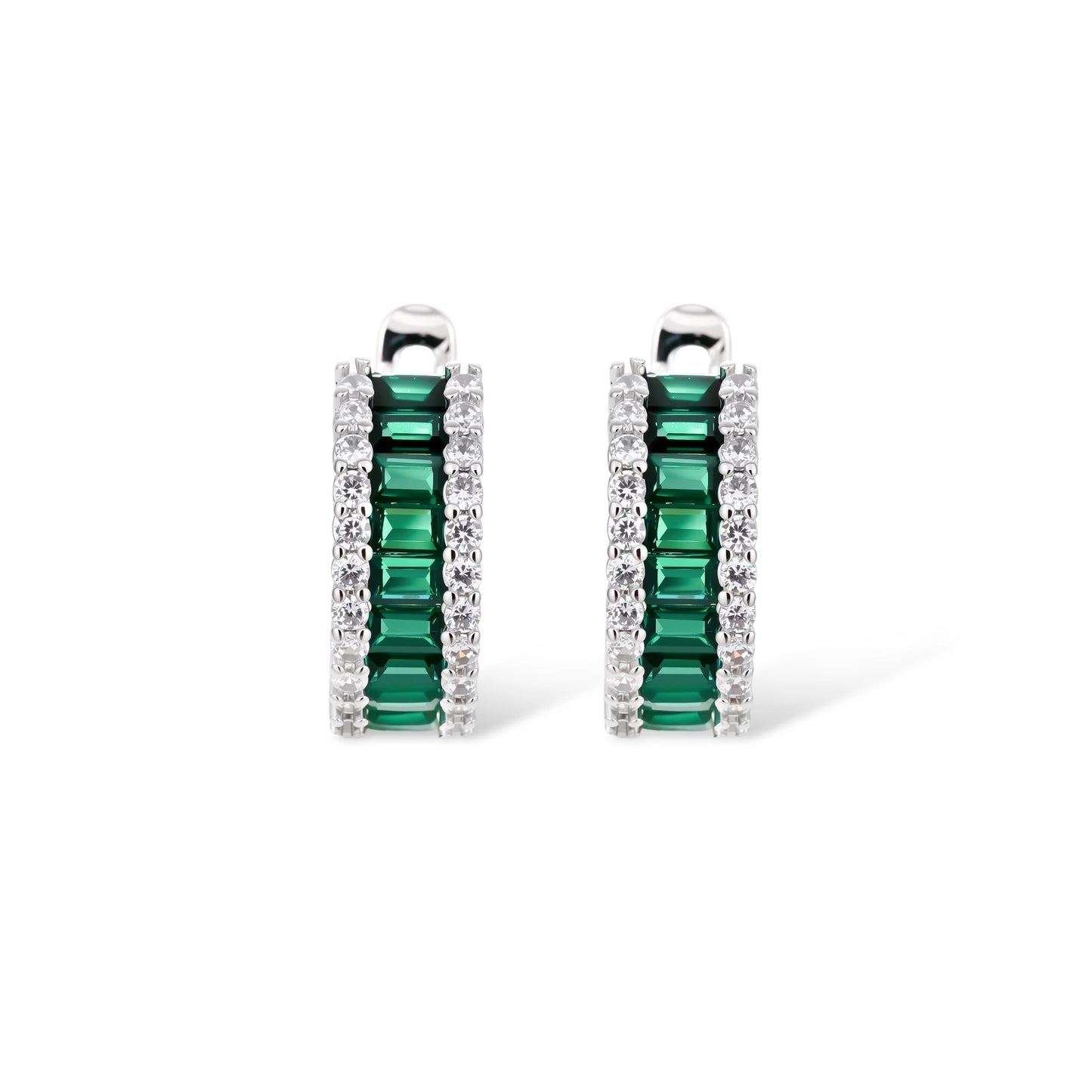 White gold plated jewelry set with emerald green rectangular stones and clear crystals in geometric rows on white background.